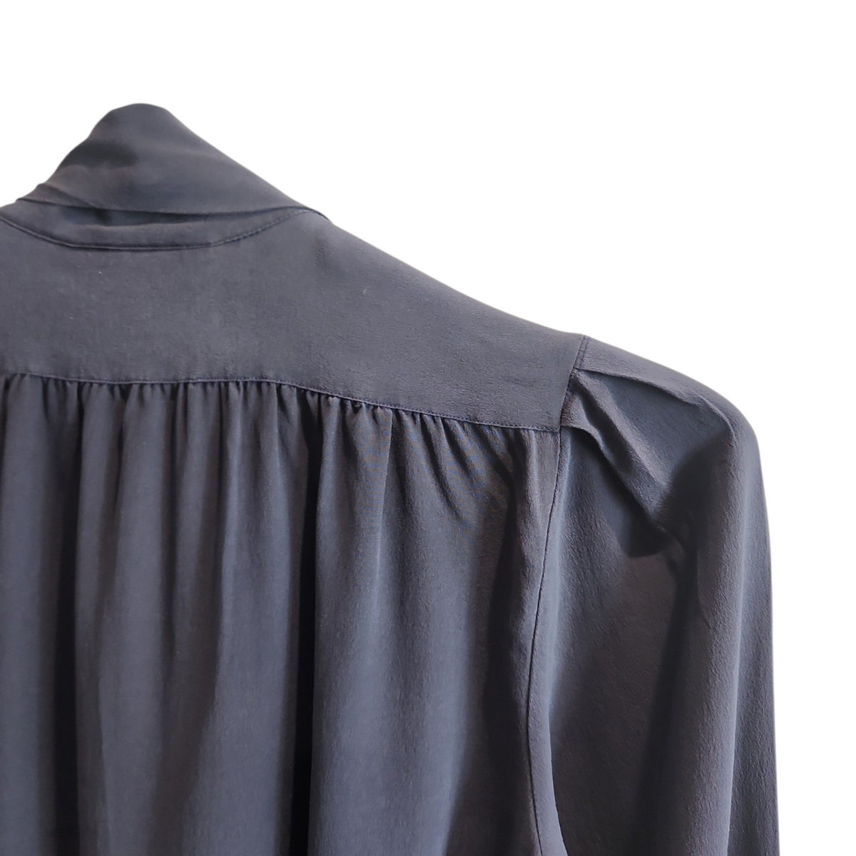 Lucille Golden Vintage, LLC slate-grey long sleeve blouse with gathered shoulders and pussy-bow neckline detail.
