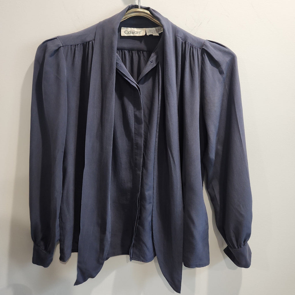 Lucille Golden Vintage, LLC slate-grey long sleeve blouse with a pussy-bow neckline and gathered shoulder detailing.