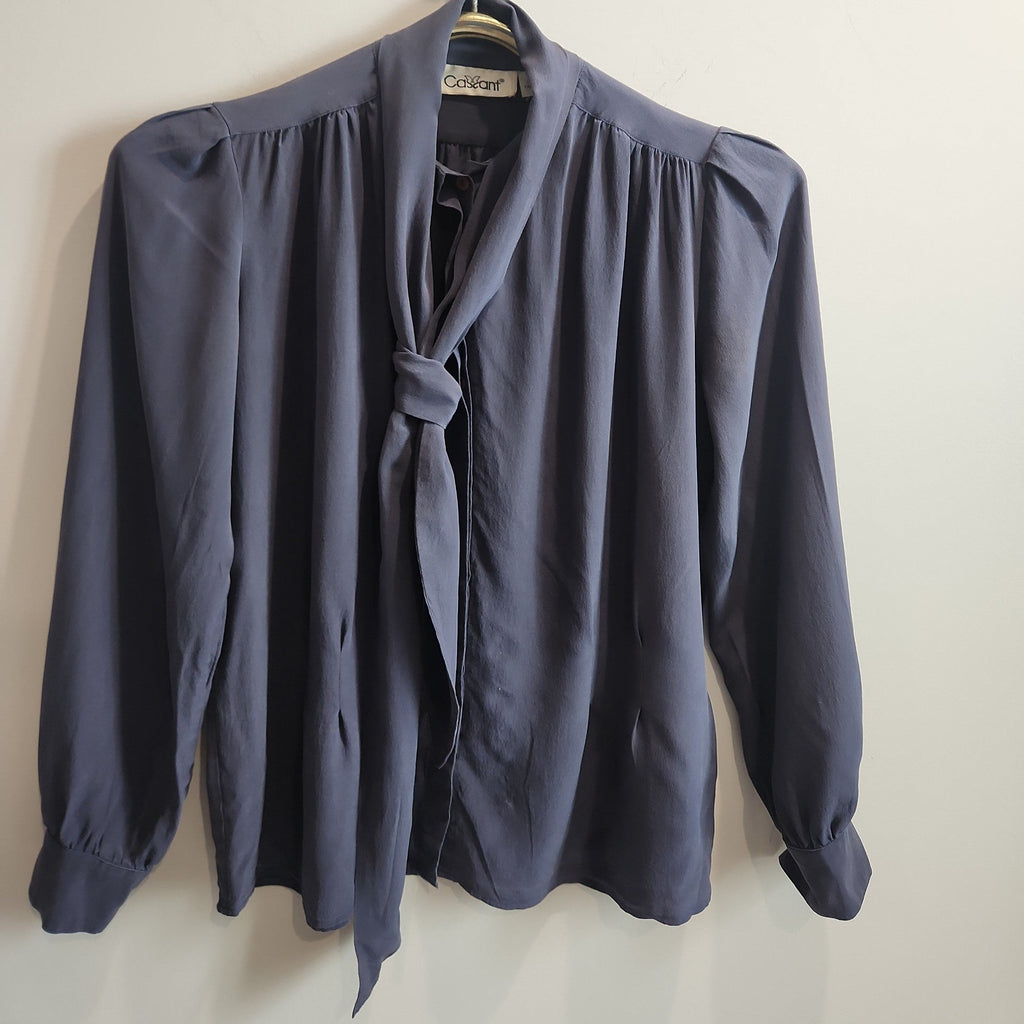 Lucille Golden Vintage, LLC slate-grey long sleeve blouse with a pussy-bow neckline and gathered shoulder detailing.