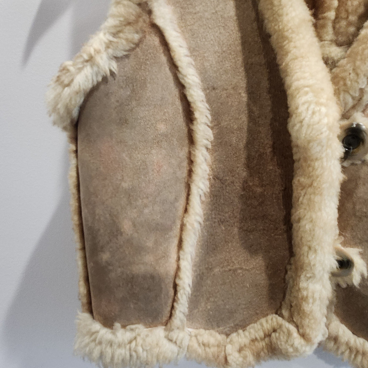 Lucille Golden Vintage, LLC tan suede vest with plush cream shearling trim and button-front closure.