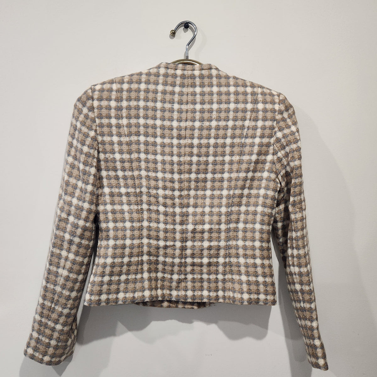 Back view of a Lucille Golden Vintage, LLC textured check blazer in beige, cream, and grey with a collarless design.