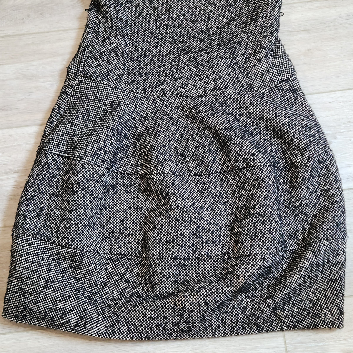 Lucille Golden Vintage, LLC black and white textured tweed mini dress with a drop-waist silhouette.