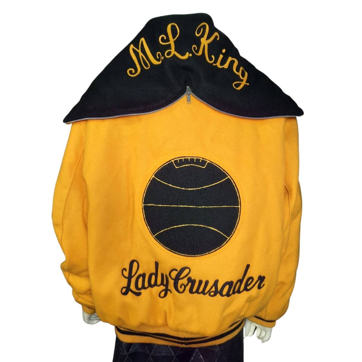 Lucille Golden Vintage, LLC 1990s gold and black wool varsity jacket with basketball patch and ML King hood detail.