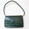 Forest green croc-embossed structured shoulder bag, front view with matching segmented shoulder strap, on a white background