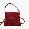 Front view of vintage Mike's Collection red ostrich-embossed leather mini handbag on a white background, with top handle visible
