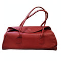 Front view of vintage Robinson Valentine brick-red leather barrel shoulder bag on a white background