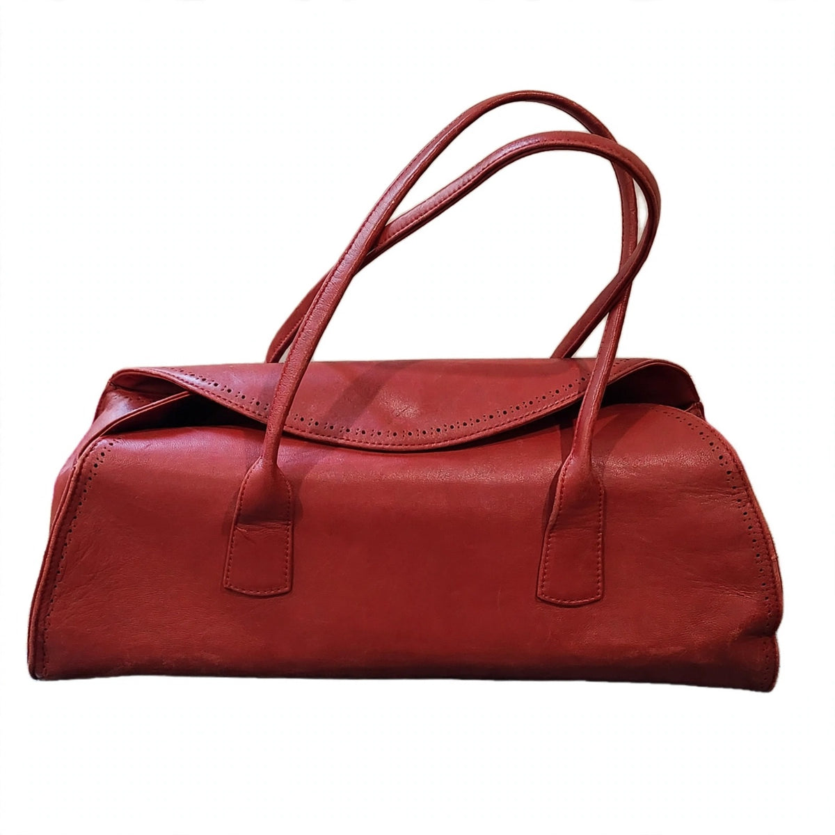 Front view of vintage Robinson Valentine brick-red leather barrel shoulder bag on a white background